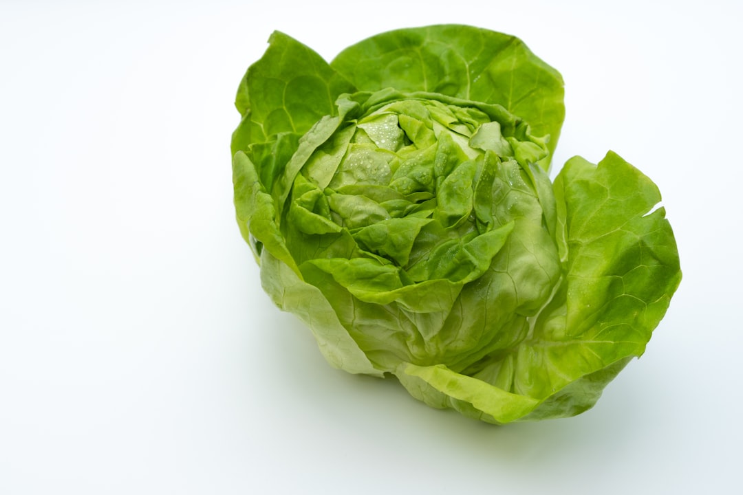 Crisper drawer filled with leafy greens and vegetables